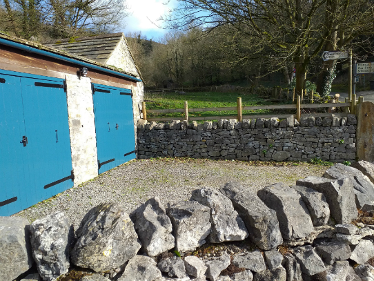 The new fencing in position at the side of the Dean Cottage double garage in Monsal Valley